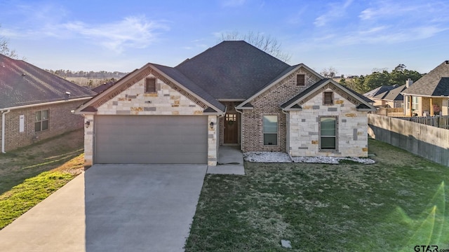 view of front facade with a garage, a shingled roof, fence, driveway, and a front yard