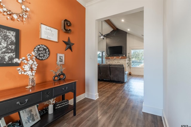 hall with dark wood-style floors, beamed ceiling, high vaulted ceiling, and baseboards