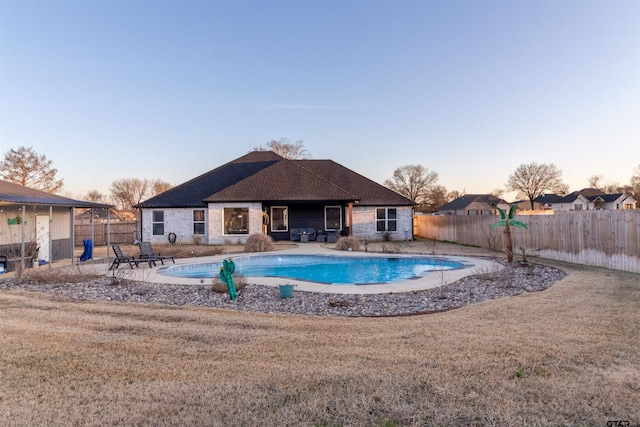 view of pool featuring a yard, a fenced backyard, a fenced in pool, and a patio