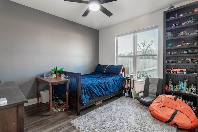 bedroom with dark wood-type flooring, ceiling fan, and multiple windows