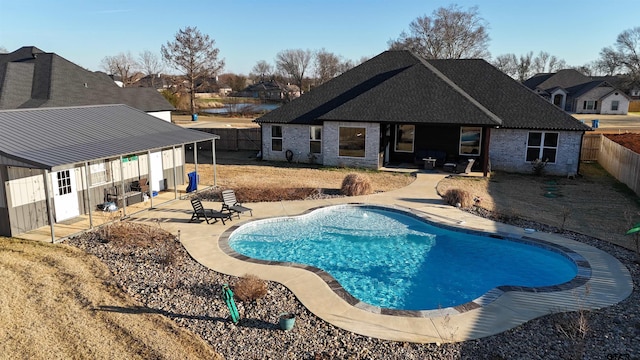 view of pool with a fenced in pool, a fenced backyard, a patio, and a residential view