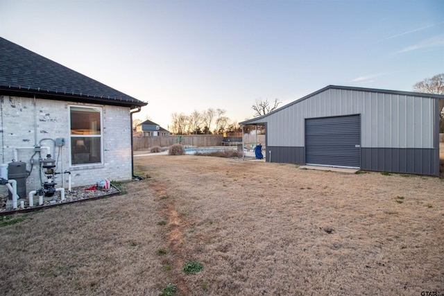 view of yard with fence, an outbuilding, and an outdoor structure