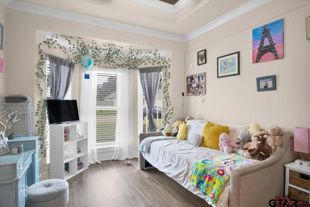 bedroom with ornamental molding and hardwood / wood-style flooring