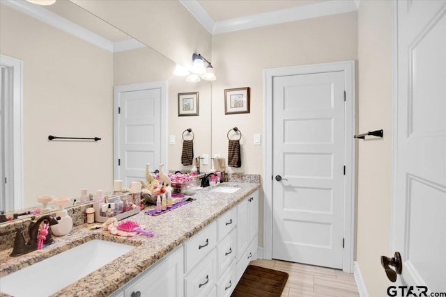 bathroom with hardwood / wood-style flooring, vanity, and ornamental molding