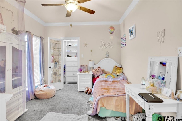 carpeted bedroom with ceiling fan and crown molding