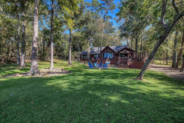 view of yard featuring a wooden deck and stairs