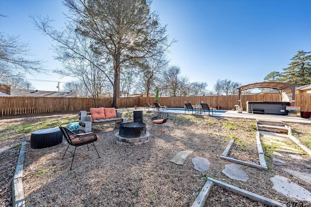 view of yard with an outdoor fire pit, a hot tub, and a patio area