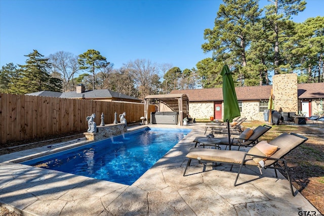 view of pool with a patio, pool water feature, and a jacuzzi