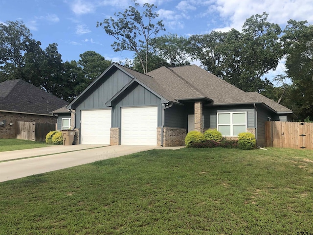 view of front facade with a garage and a front lawn