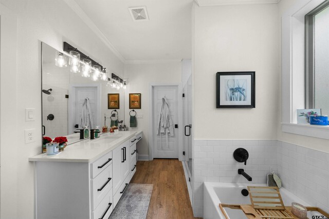 full bath featuring visible vents, wood finished floors, a bathtub, vanity, and a shower stall