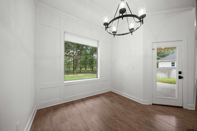 21488 Forest Pl, Flint, TX 75762 - unfurnished dining area featuring a chandelier, plenty of natural light, wood finished floors, and crown molding