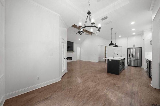 21488 Forest Pl, Flint, TX 75762 - kitchen with stainless steel fridge, a chandelier, open floor plan, recessed lighting, and light countertops