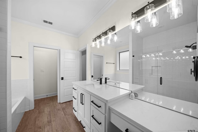 21488 Forest Pl, Flint, TX 75762 - bathroom with crown molding, vanity, a stall shower, wood finished floors, and a tub to relax in