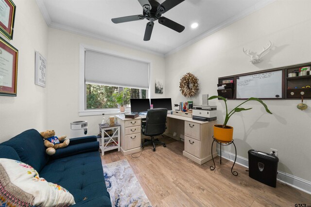 office area with a ceiling fan, light wood-type flooring, crown molding, and baseboards