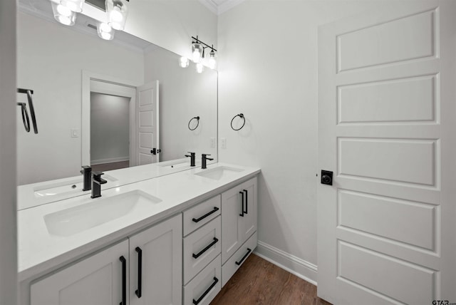 21488 Forest Pl, Flint, TX 75762 - bathroom with ornamental molding, double vanity, and wood finished floors