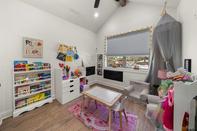 recreation room featuring lofted ceiling with beams, recessed lighting, wood finished floors, and baseboards