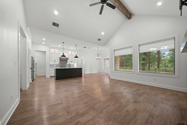21488 Forest Pl, Flint, TX 75762 - unfurnished living room featuring beam ceiling, recessed lighting, a chandelier, a ceiling fan, and wood finished floors