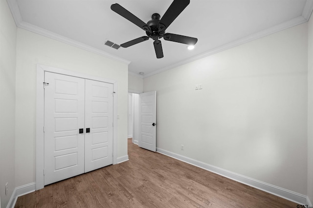 21488 Forest Pl, Flint, TX 75762 - unfurnished bedroom with ornamental molding, wood finished floors, a closet, and a ceiling fan