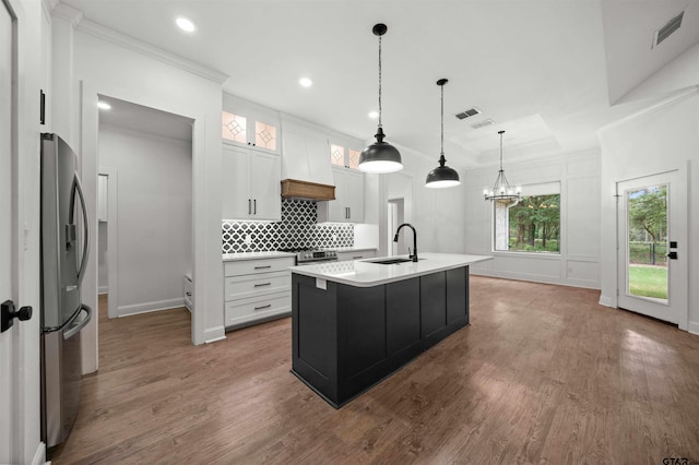 21488 Forest Pl, Flint, TX 75762 - kitchen featuring stainless steel appliances, ornamental molding, dark wood-type flooring, tasteful backsplash, and light countertops
