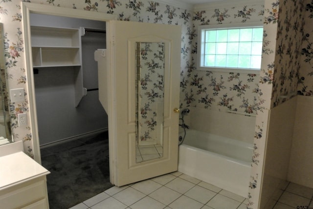 bathroom with a bath, vanity, and tile patterned floors