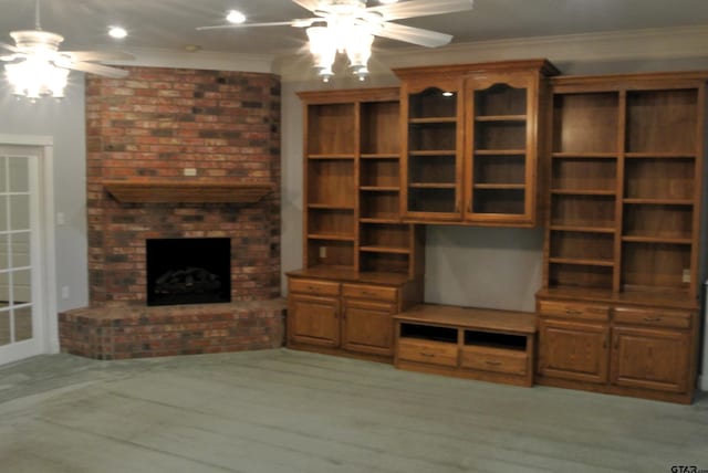 unfurnished living room featuring hardwood / wood-style floors, ceiling fan, a fireplace, and ornamental molding