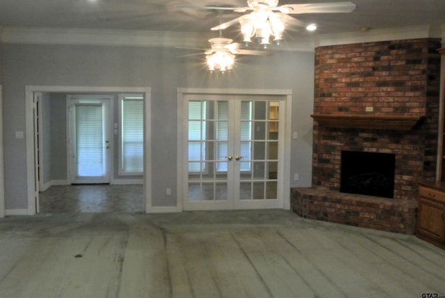 unfurnished living room featuring a brick fireplace, ceiling fan, french doors, and ornamental molding