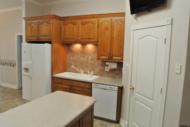 kitchen with crown molding, sink, white appliances, and backsplash