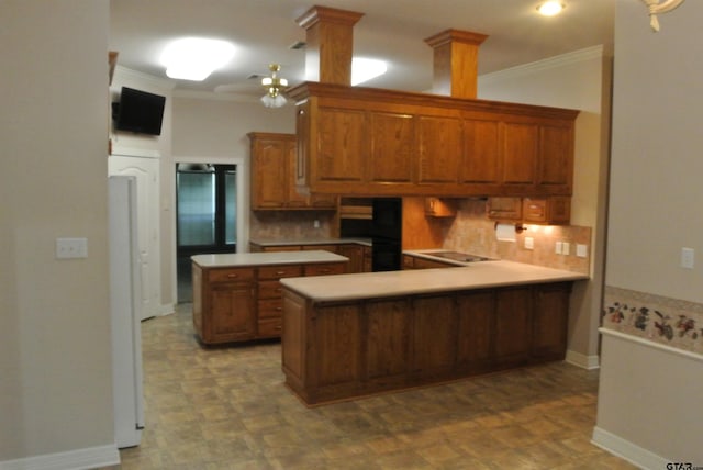 kitchen featuring ornamental molding, decorative columns, kitchen peninsula, and ceiling fan