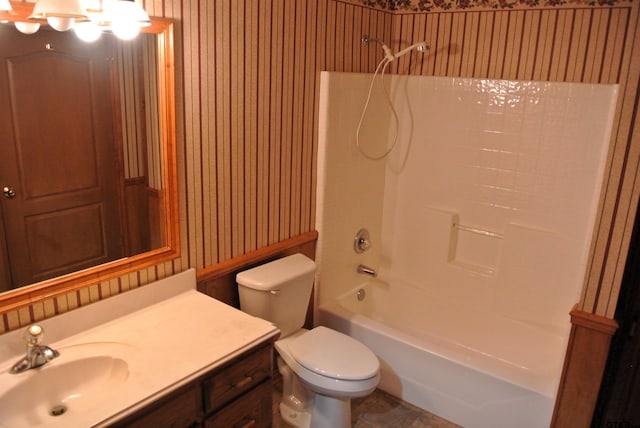 full bathroom featuring toilet, vanity, and shower / washtub combination