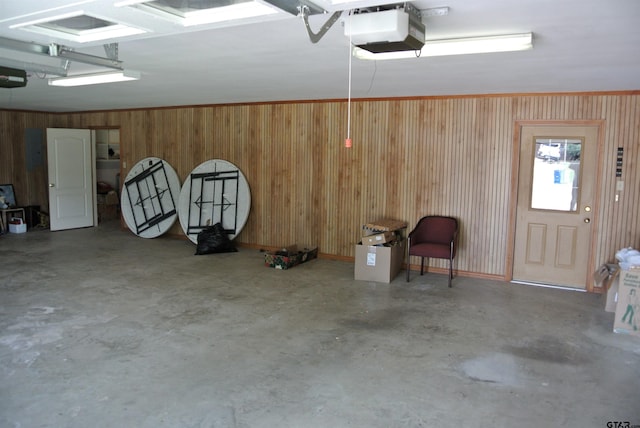 garage featuring wooden walls and a garage door opener