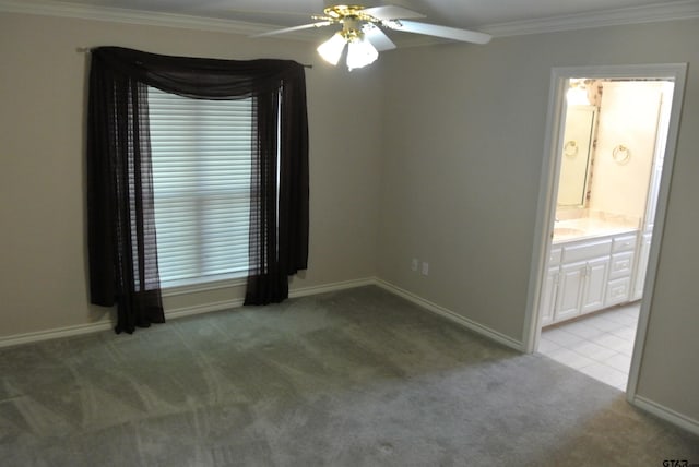 empty room featuring light carpet, ceiling fan, and crown molding