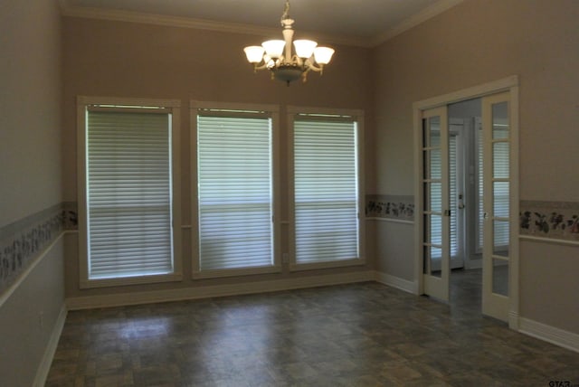 spare room with ornamental molding and a notable chandelier