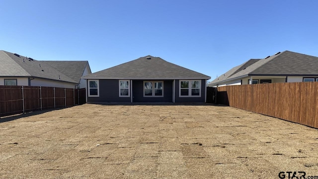 back of property featuring a fenced backyard