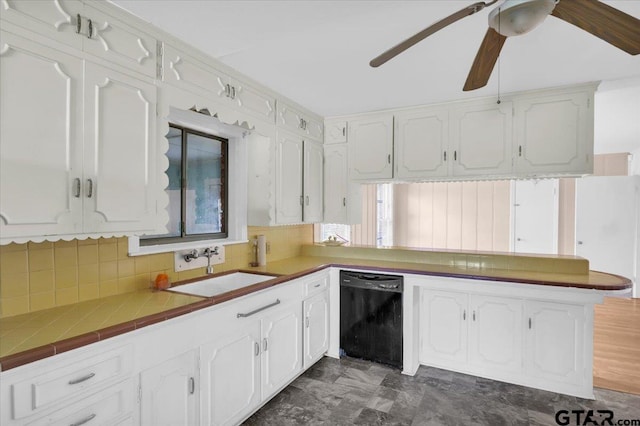 kitchen with tile countertops, white cabinetry, sink, and dishwasher