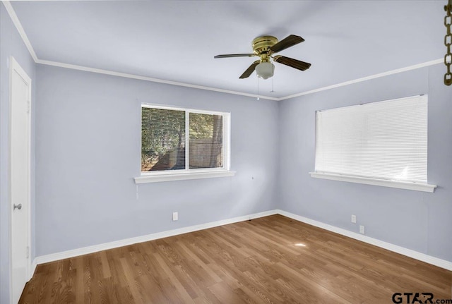 unfurnished room featuring hardwood / wood-style flooring, ceiling fan, and crown molding