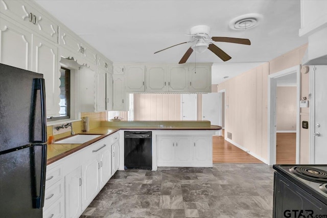 kitchen featuring white cabinets, kitchen peninsula, black appliances, and sink