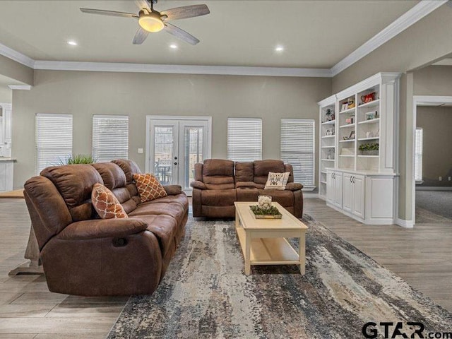 living room with ceiling fan, french doors, crown molding, and light hardwood / wood-style flooring