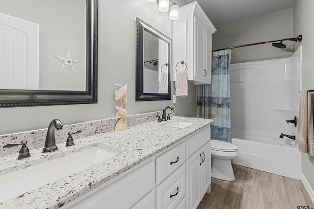 full bathroom with toilet, vanity, wood-type flooring, and shower / bath combo