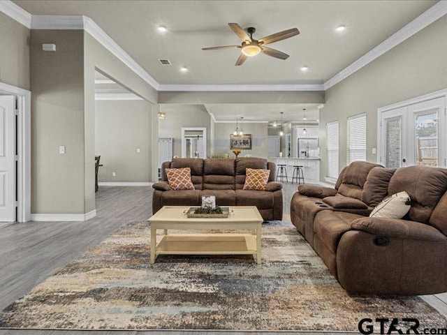 living room featuring french doors, ceiling fan, crown molding, and hardwood / wood-style floors