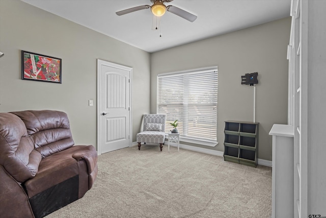 sitting room with ceiling fan and light carpet