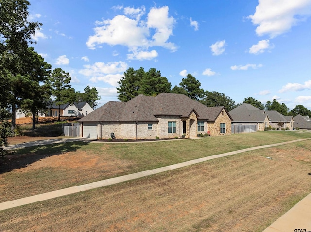 view of front of property featuring a front lawn and a garage