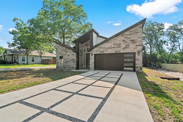 contemporary home with a front yard and a garage