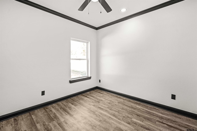 empty room with ceiling fan, wood-type flooring, and ornamental molding