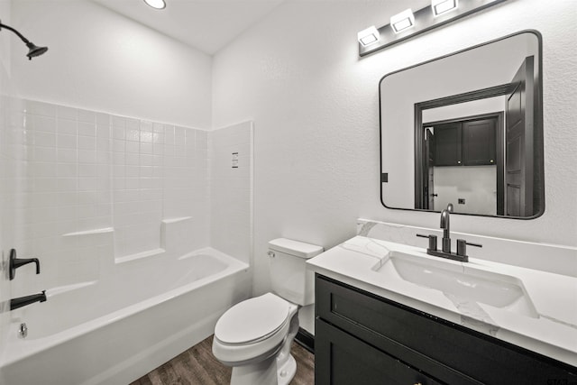 full bathroom featuring hardwood / wood-style flooring, vanity, toilet, and bathtub / shower combination