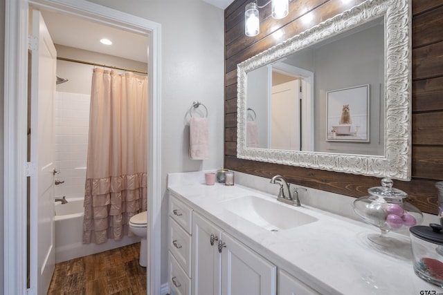 full bathroom featuring vanity, wood-type flooring, shower / bath combination with curtain, and toilet