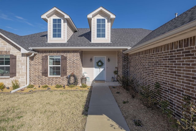 property entrance with a lawn