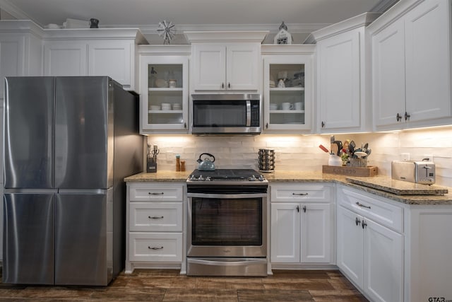 kitchen featuring dark wood-type flooring, appliances with stainless steel finishes, decorative backsplash, and white cabinets