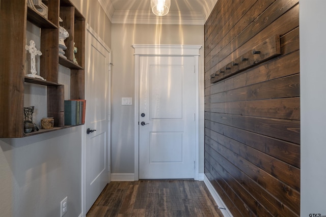 entryway with crown molding, dark hardwood / wood-style flooring, and wood walls