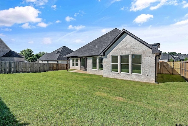 rear view of house with a lawn