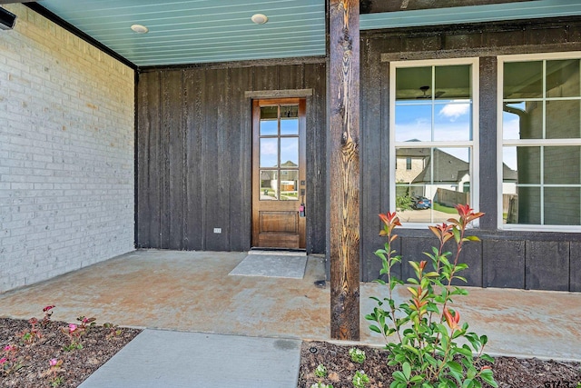 view of exterior entry featuring a patio